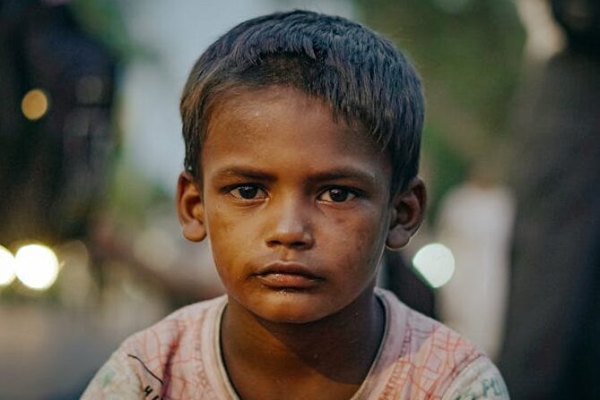 Captivating portrait of a young boy in the streets of Delhi, India, conveying depth and emotion.
